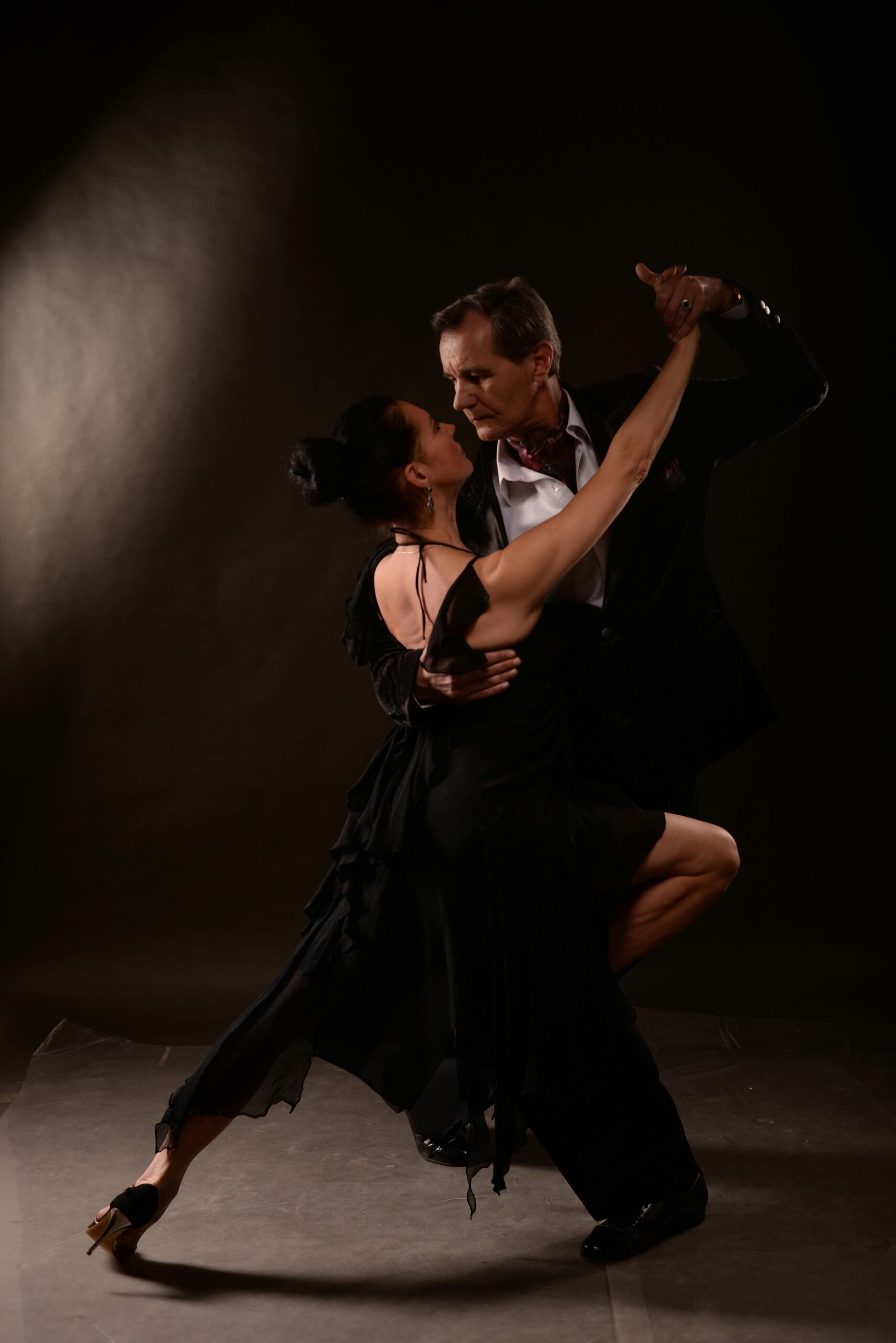 Dynamic tango dancers performing an elegant routine on stage, capturing passion and movement.